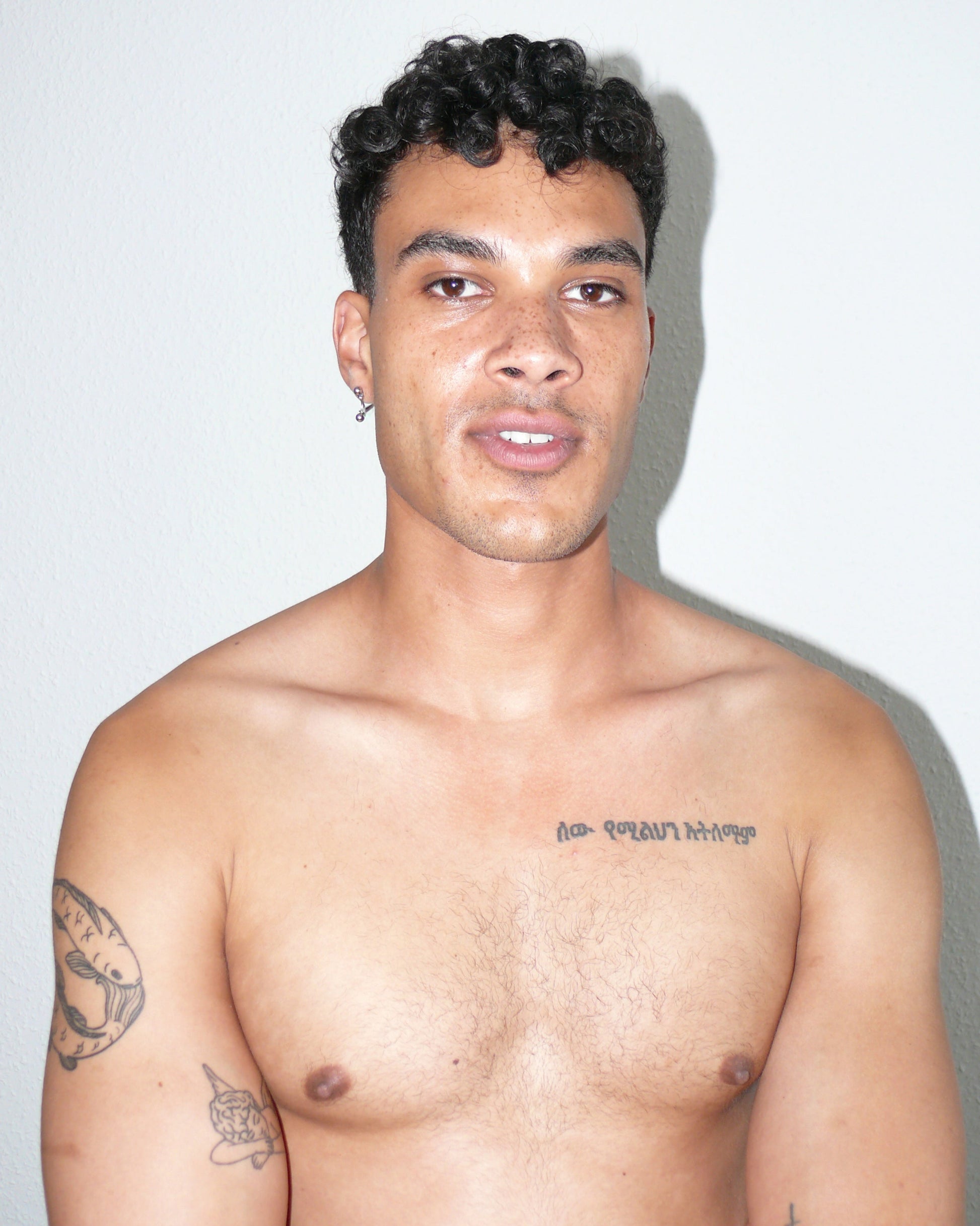 Mini banana piercing earrings frontal portrait on poc model