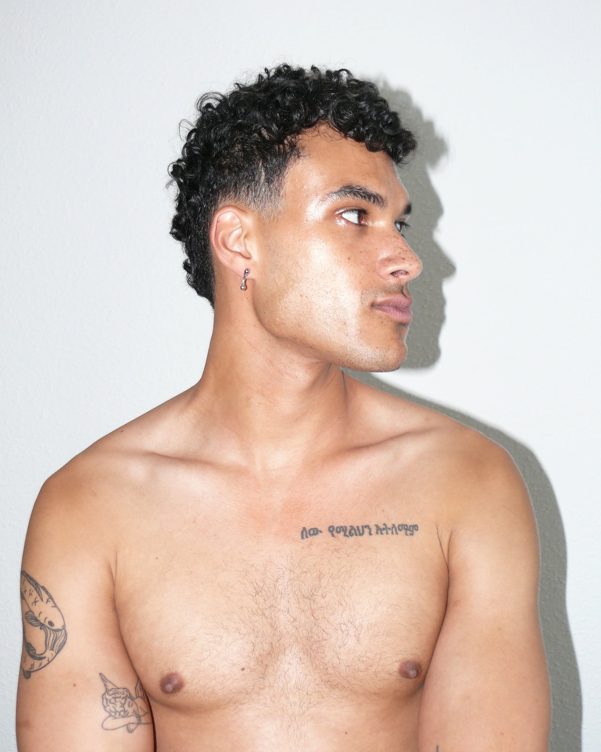 Mini banana piercing earrings side portrait on poc model