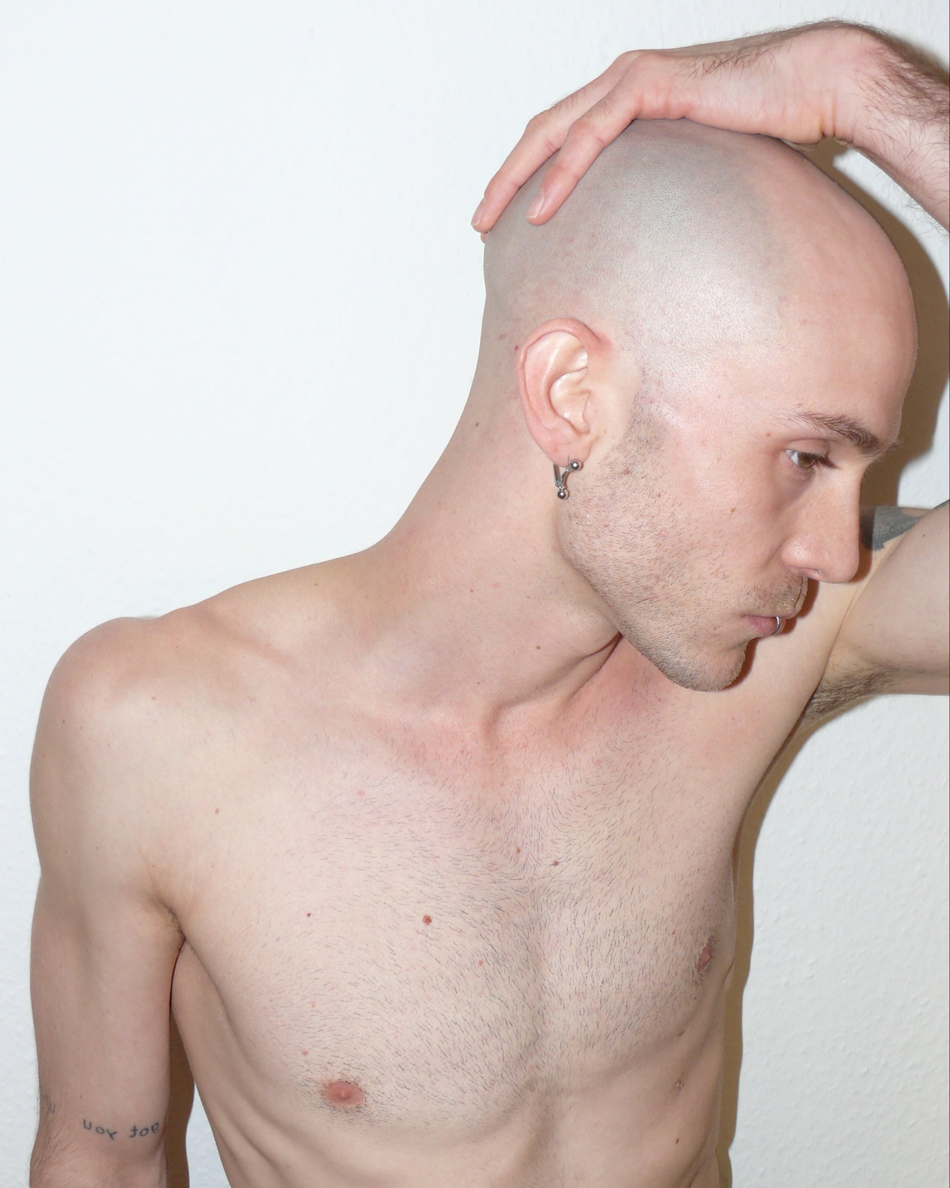 Mini banana piercing earrings side portrait on white model