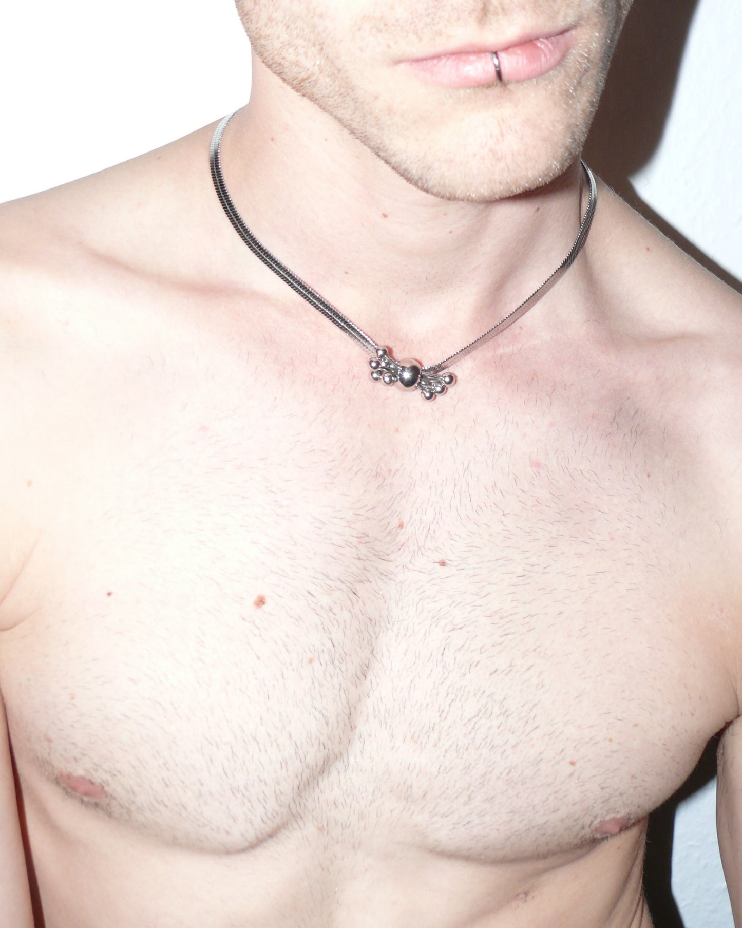 Multiple steel barbells decoration flat snake chain necklace top close-up on model