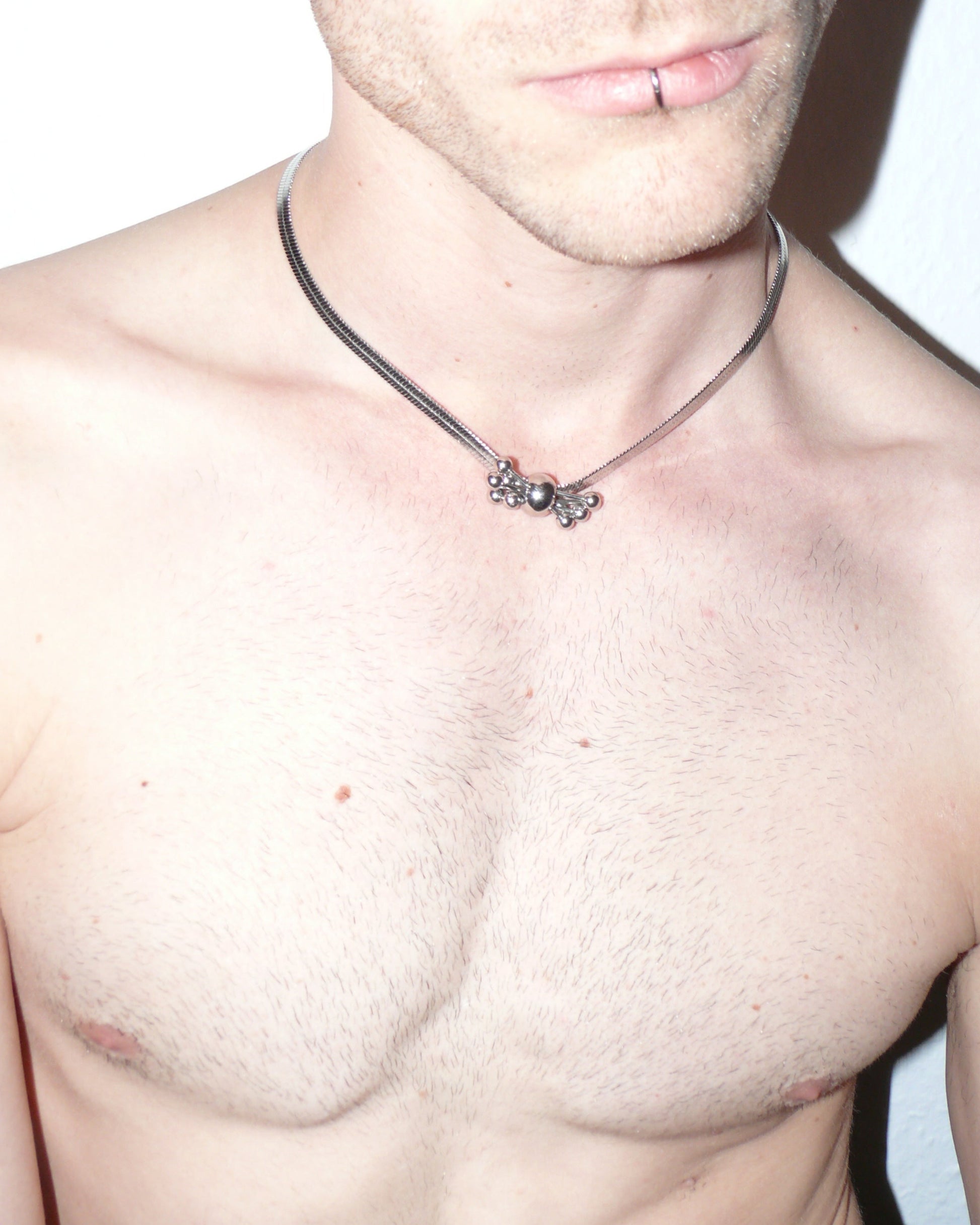 Multiple steel barbells decoration flat snake chain necklace top close-up on model