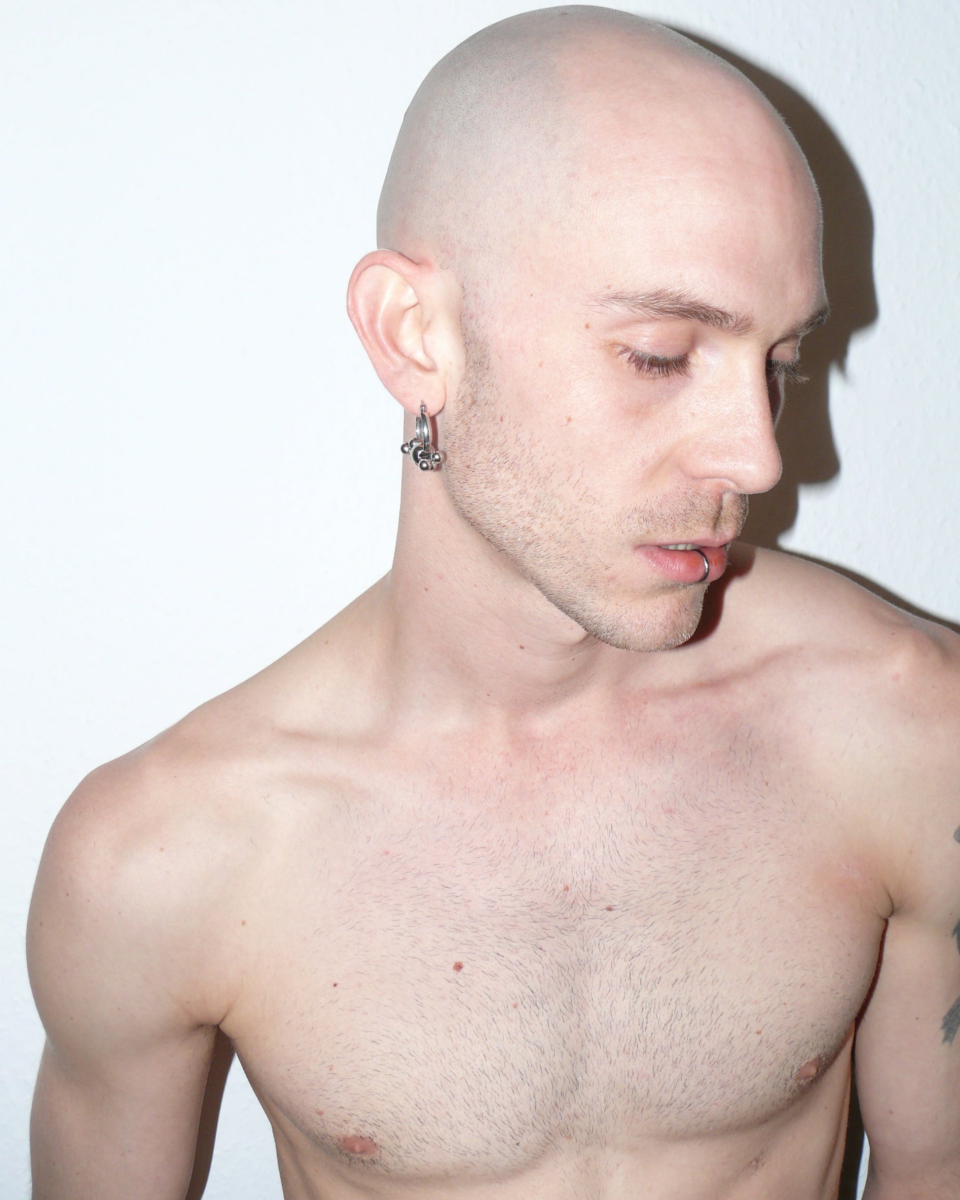 Multiple steel barbells decoration hoop earrings side portrait on model