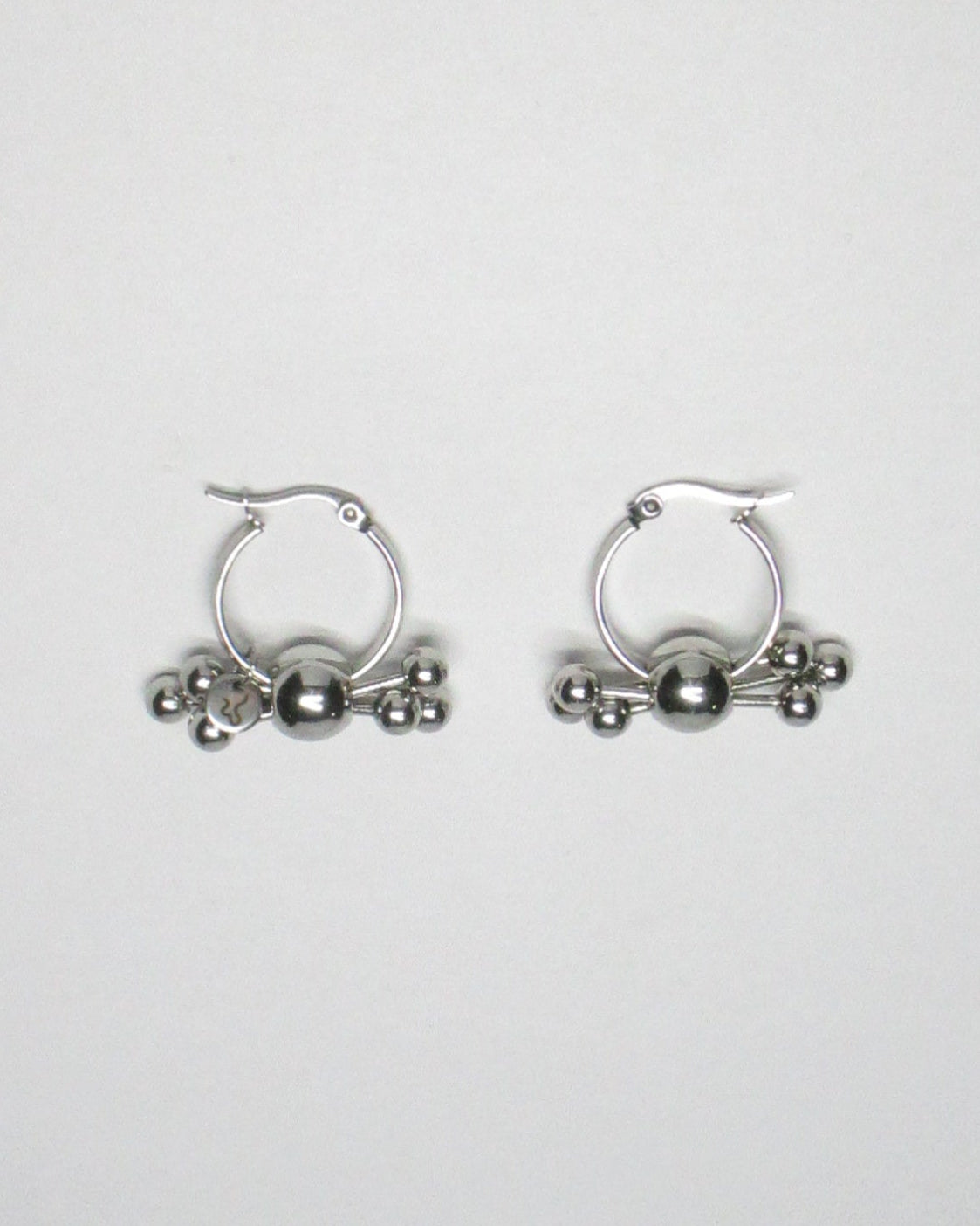 Multiple steel barbells decoration hoop earrings top still portrait
