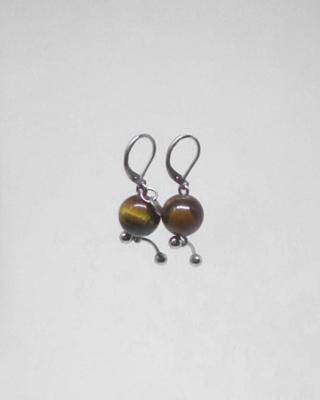 Pair of earrings with brown beads on a white background