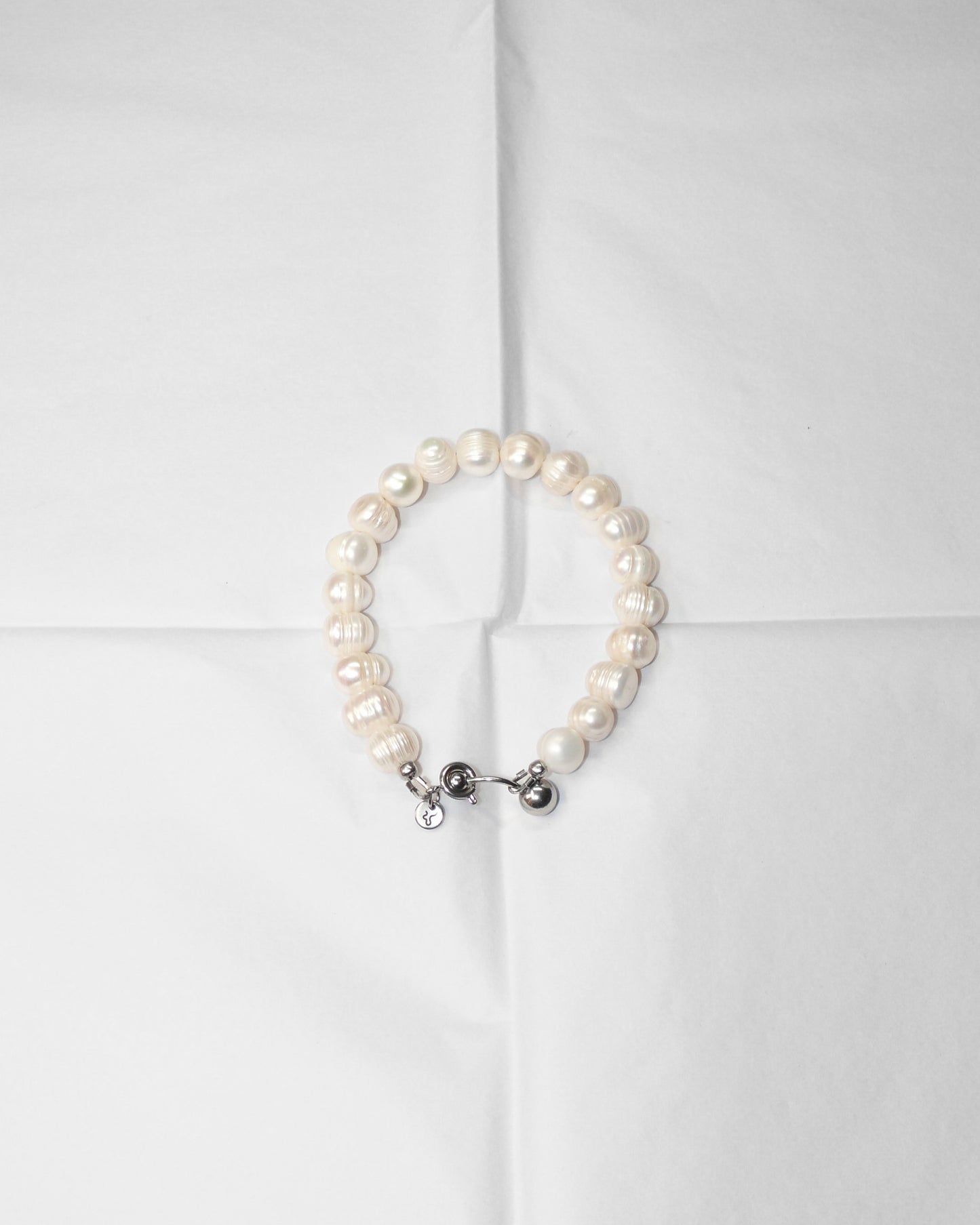 Pearl bracelet on folded tissue paper