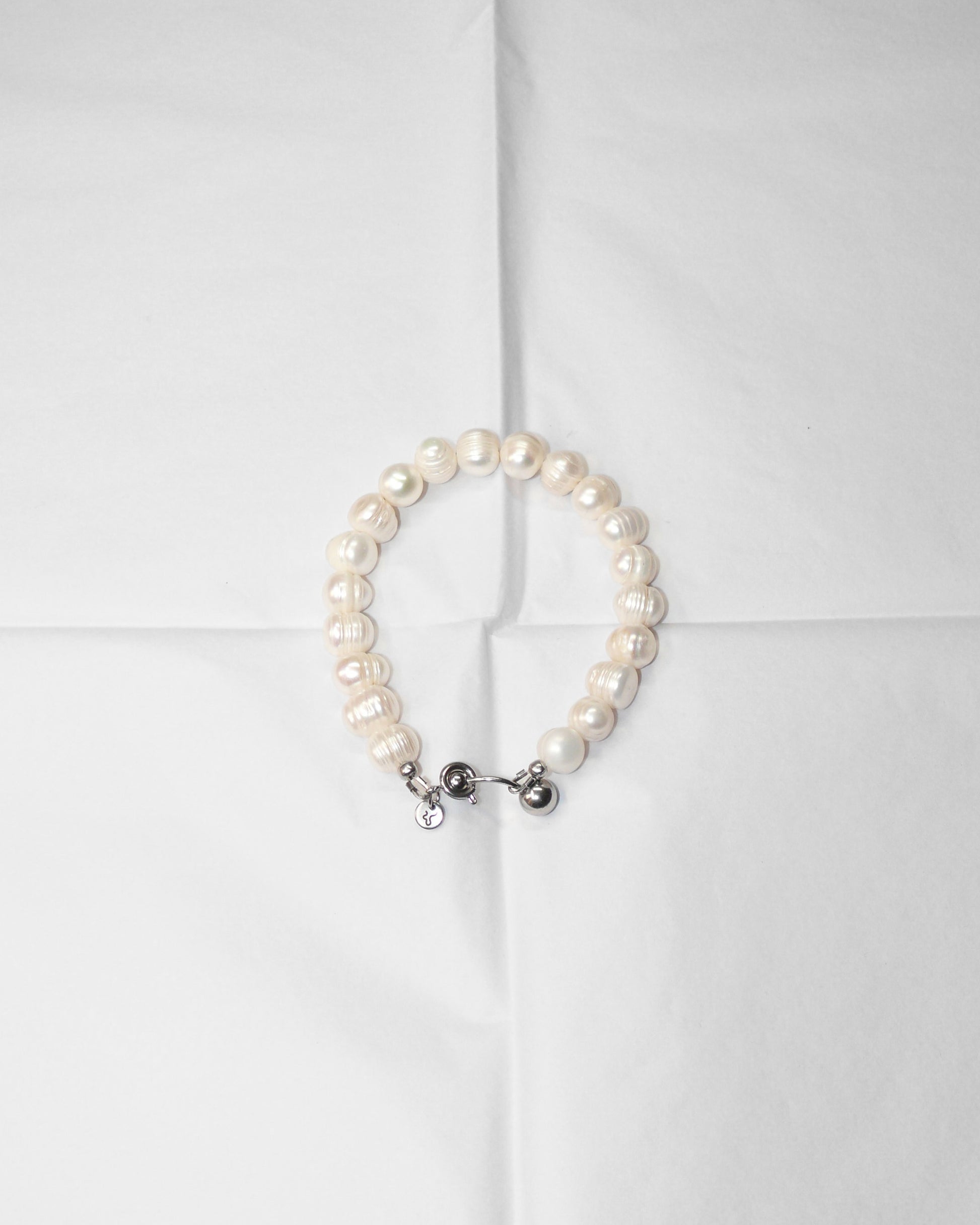 Pearl bracelet on folded tissue paper
