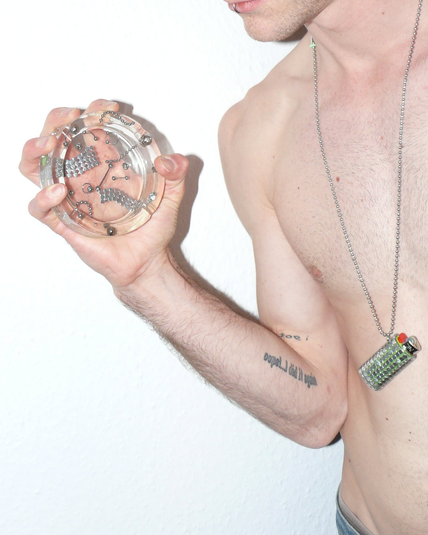 Person holding a resin hastray with a plain background