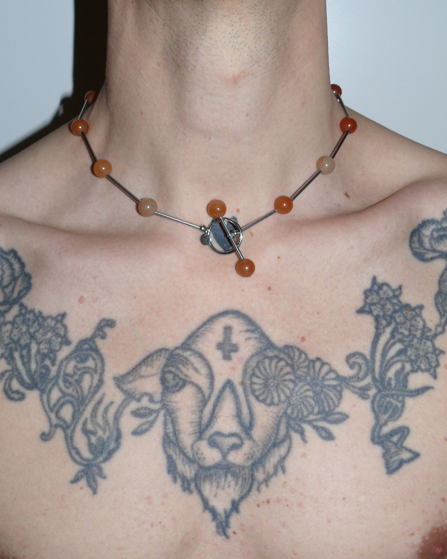 Red beaded necklace representing fire signs close up on model