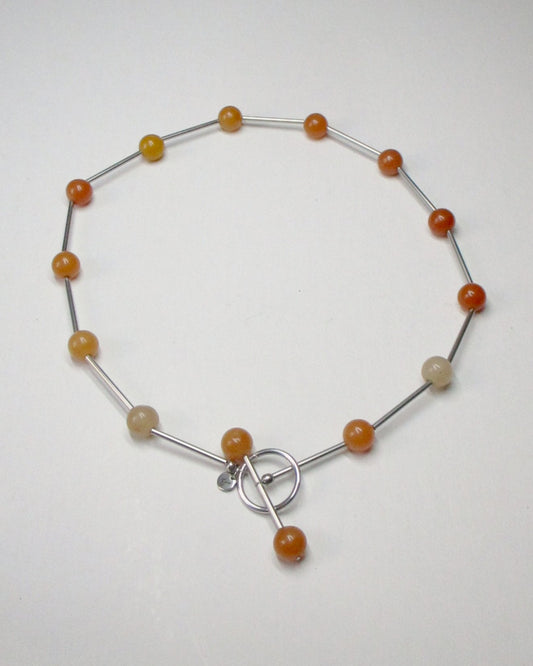 Red beaded necklace representing fire signs