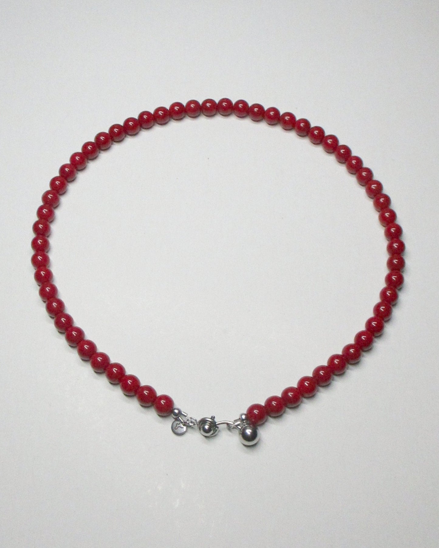 Red coral beads necklace with piercing closure still portrait