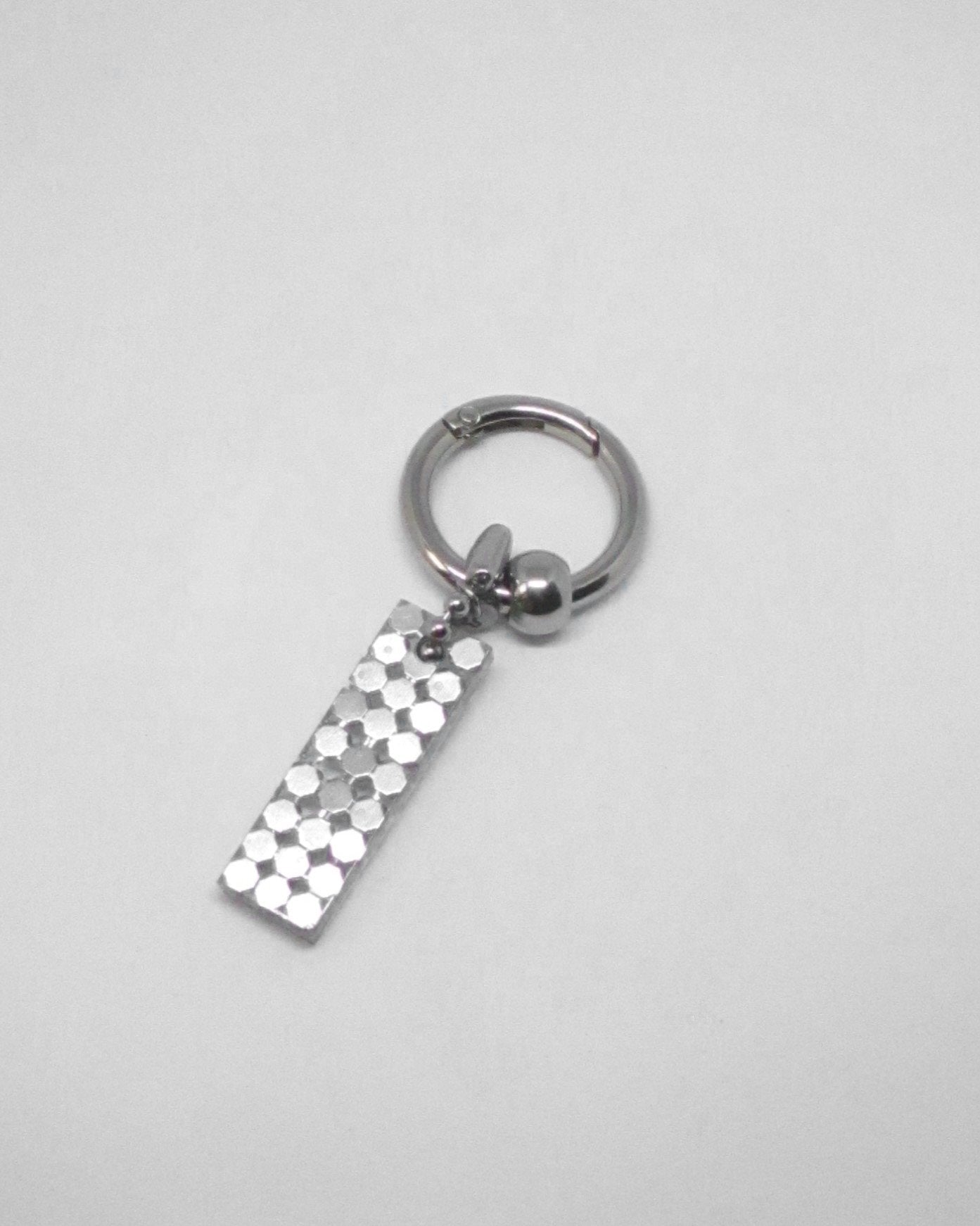 Silver keychain with a rectangular tag on a light gray background