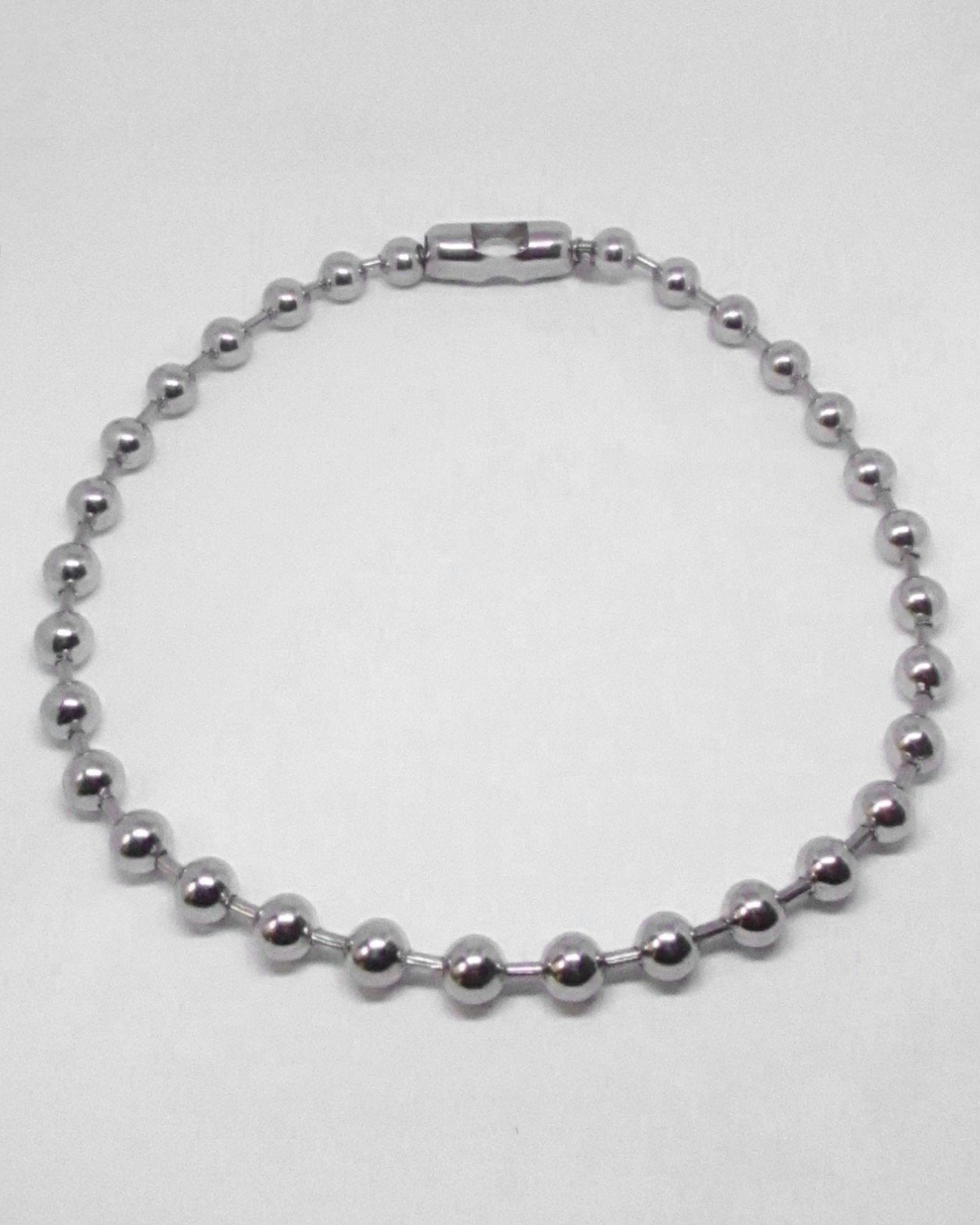 Silver beaded necklace on a white background