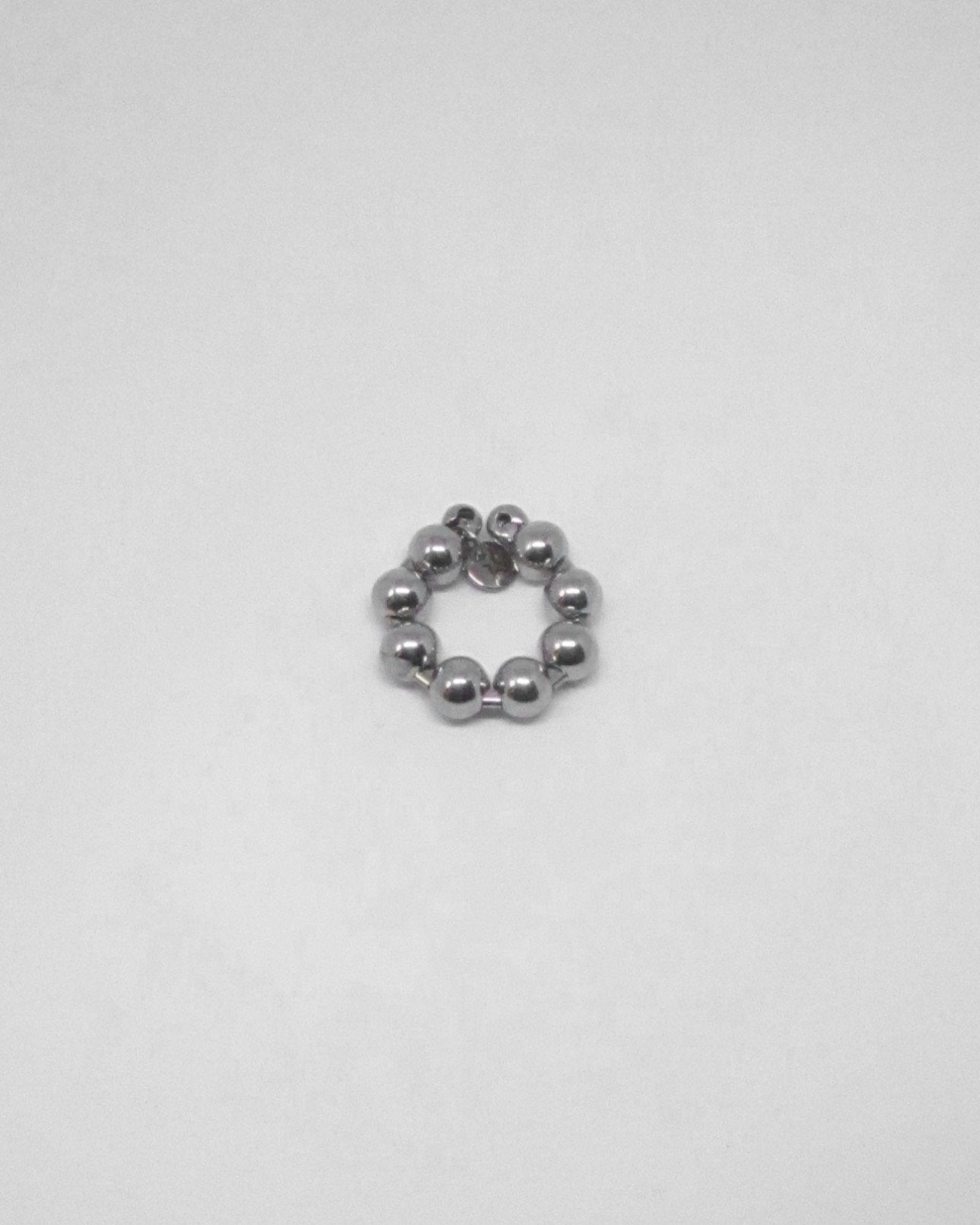 Silver beaded ring on a light gray background