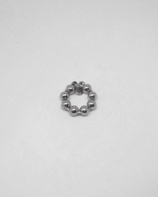 Silver beaded ring on a light gray background