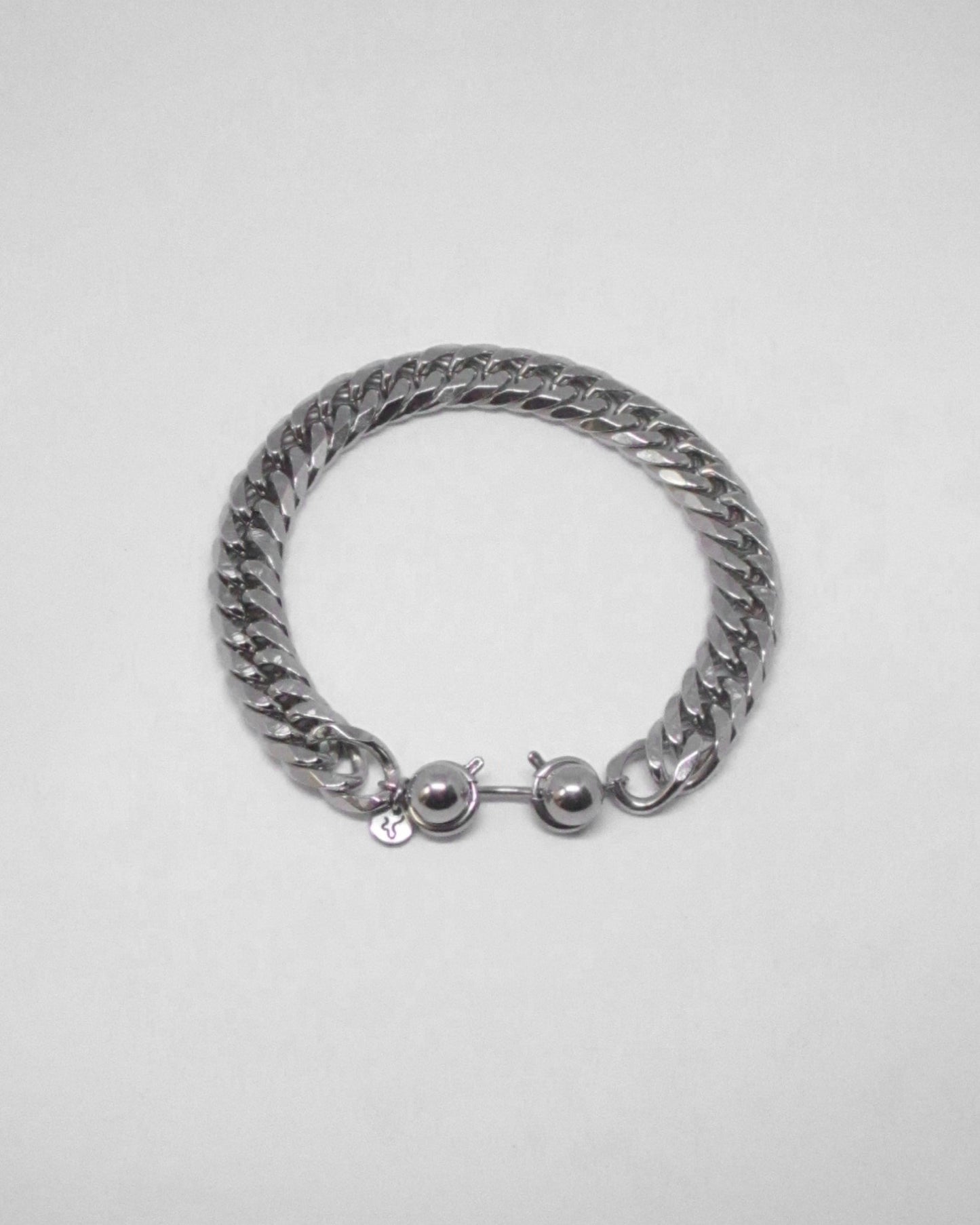 Silver chain bracelet with spherical ends on a light gray background