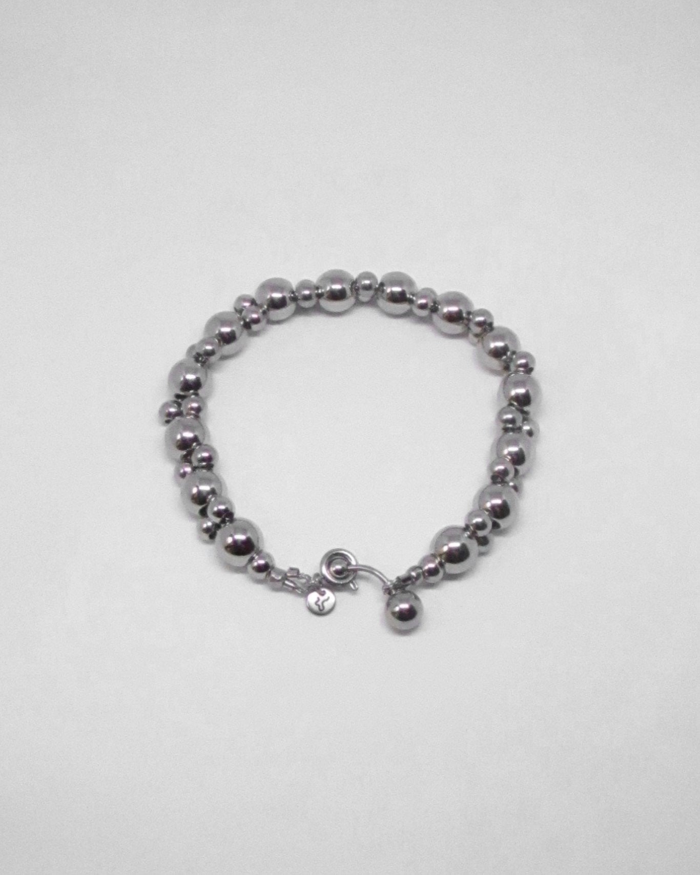 Silver double beaded bracelet on a light gray background