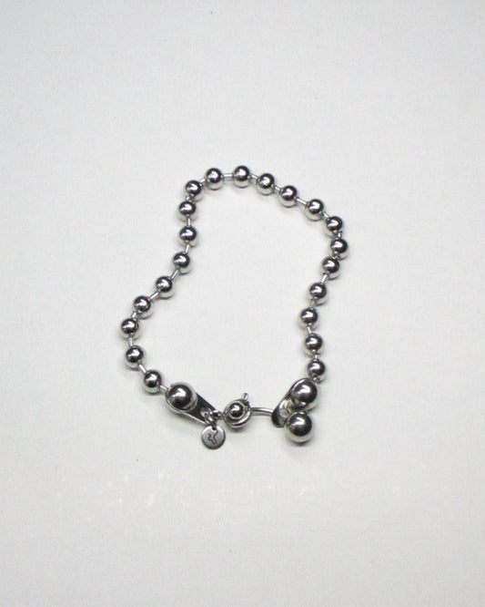 Steel ball chain bracelet with piercing closure still fluid portrait