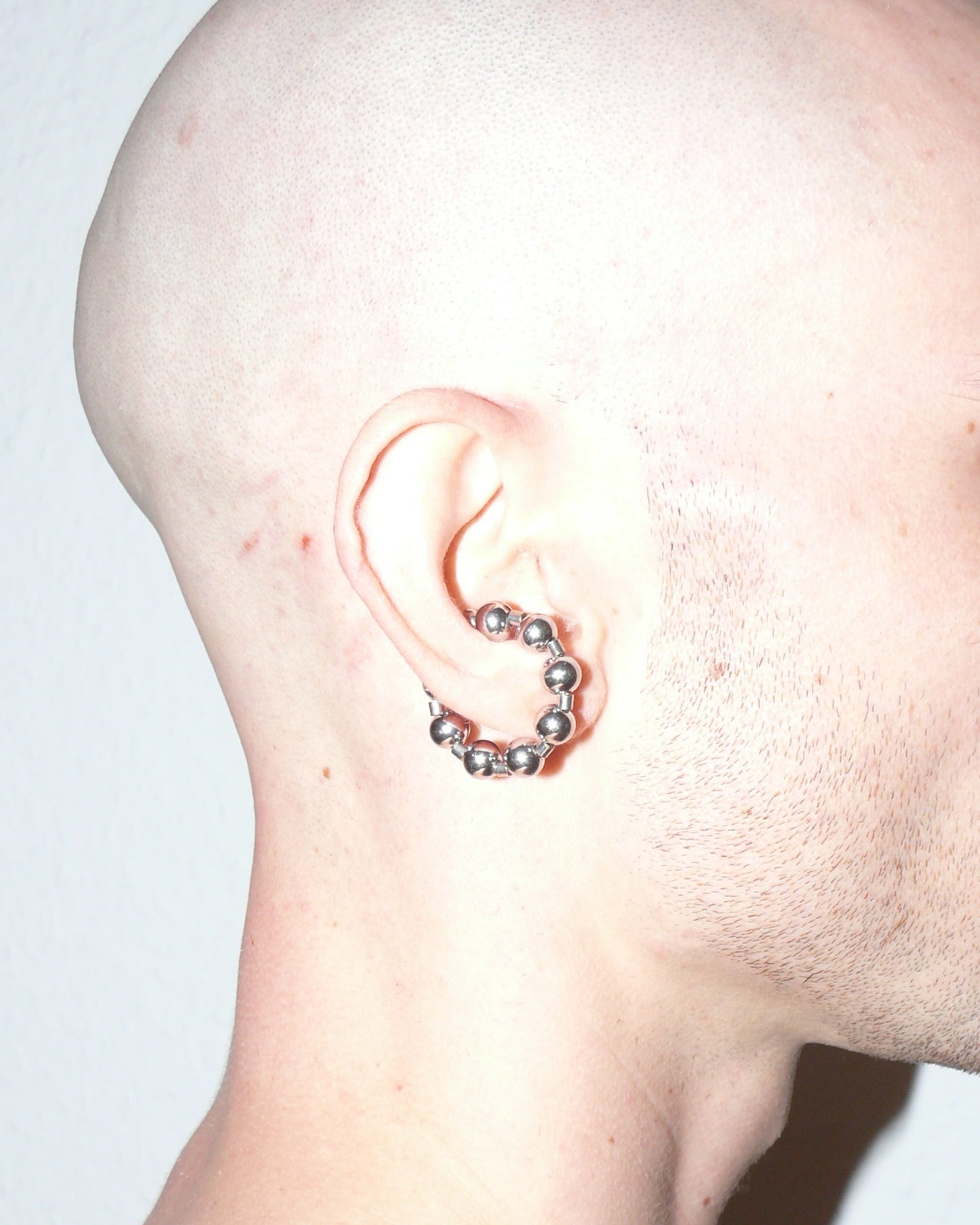 Steel ball chain cuff close up portrait lateral