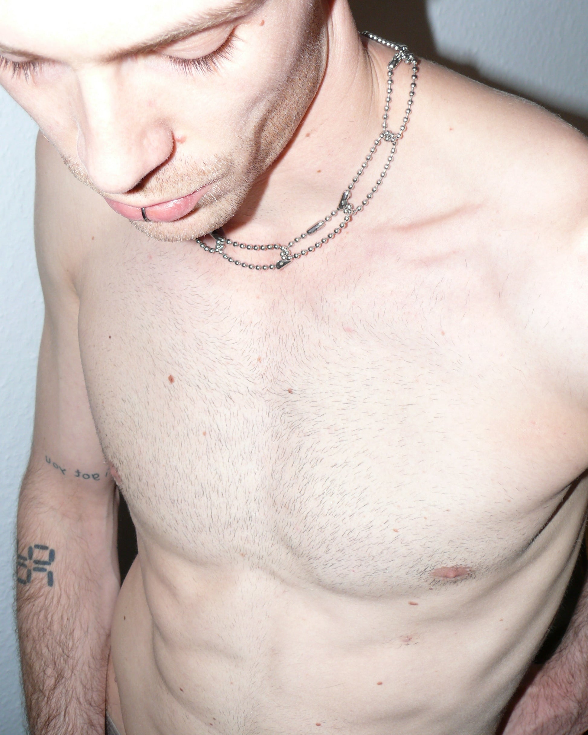 Steel ball chain multiple rings necklace close up top pov portrait on model