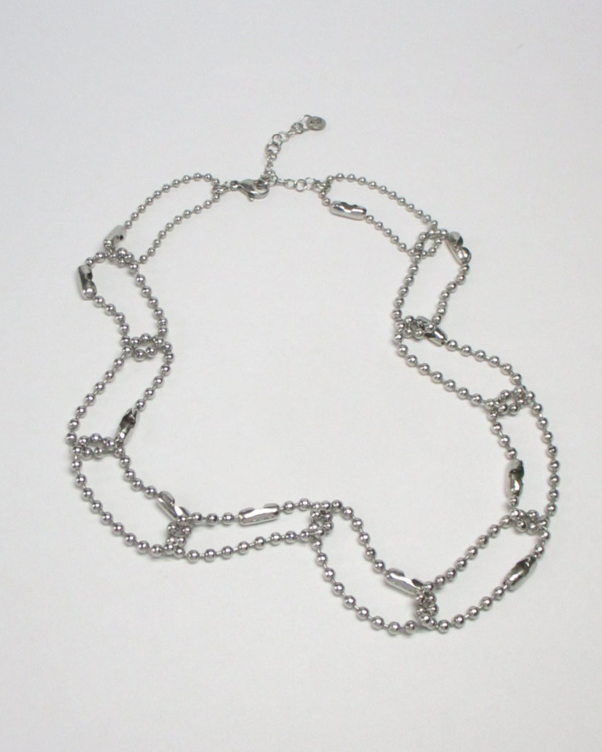Steel ball chain multiple rings necklace fluid still portrait