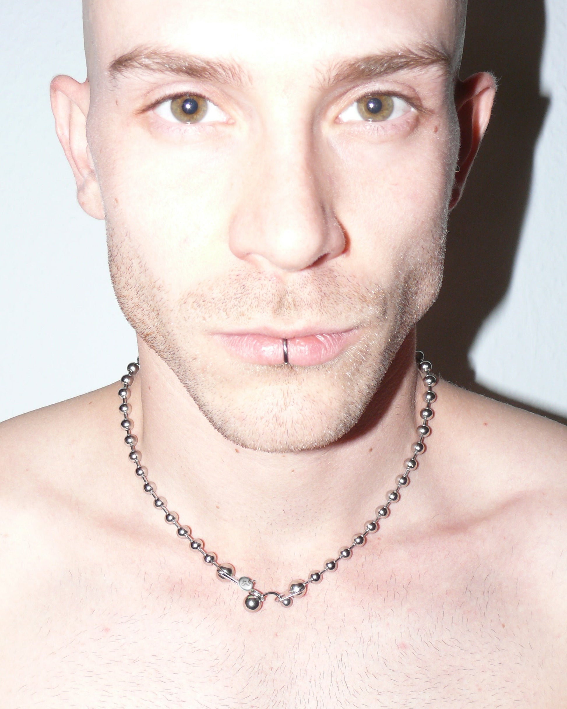 Steel ball chain necklace with piercing closure close up portrait on model