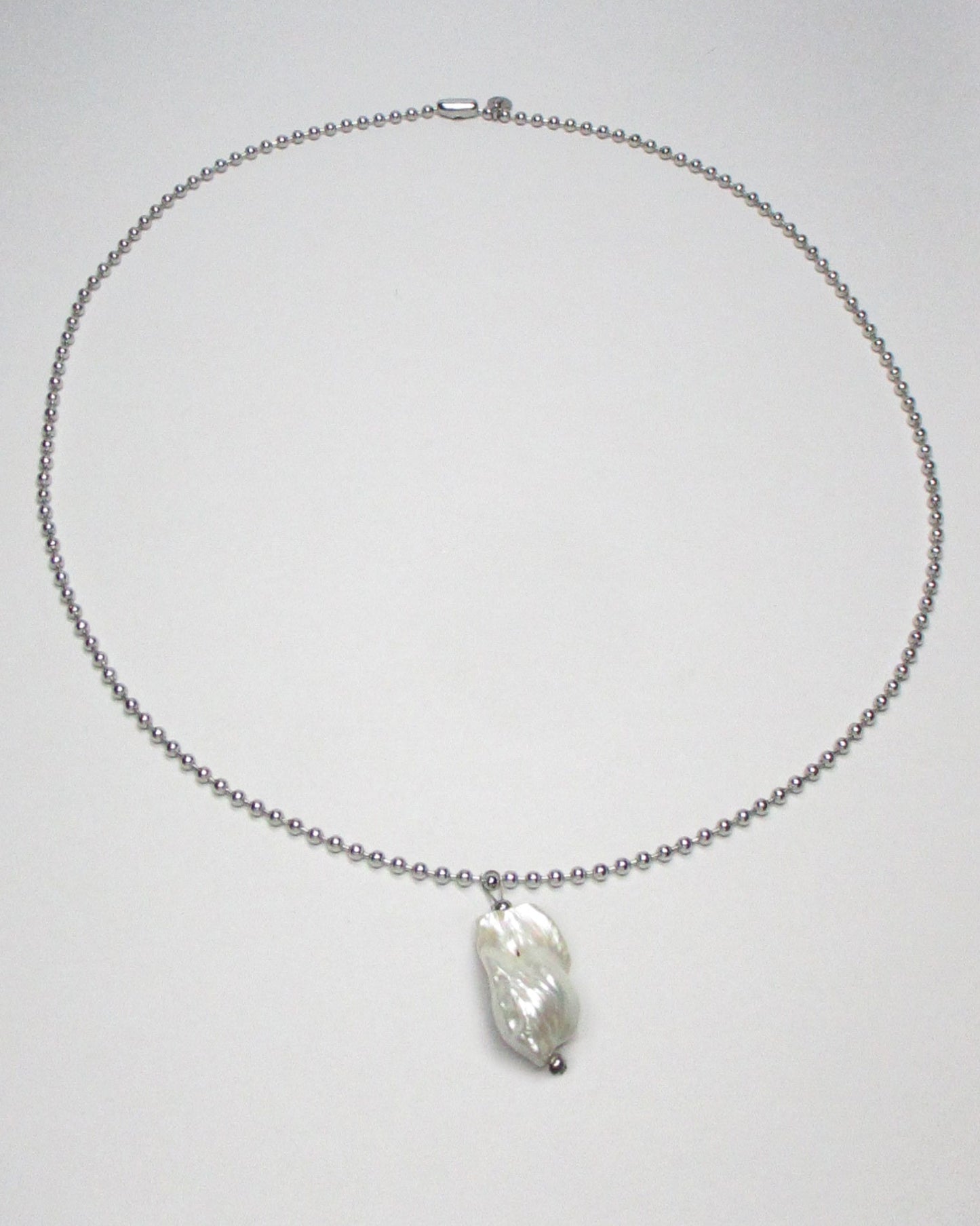 Steel ball chain with baroque freshwater pearl pendant still portrait
