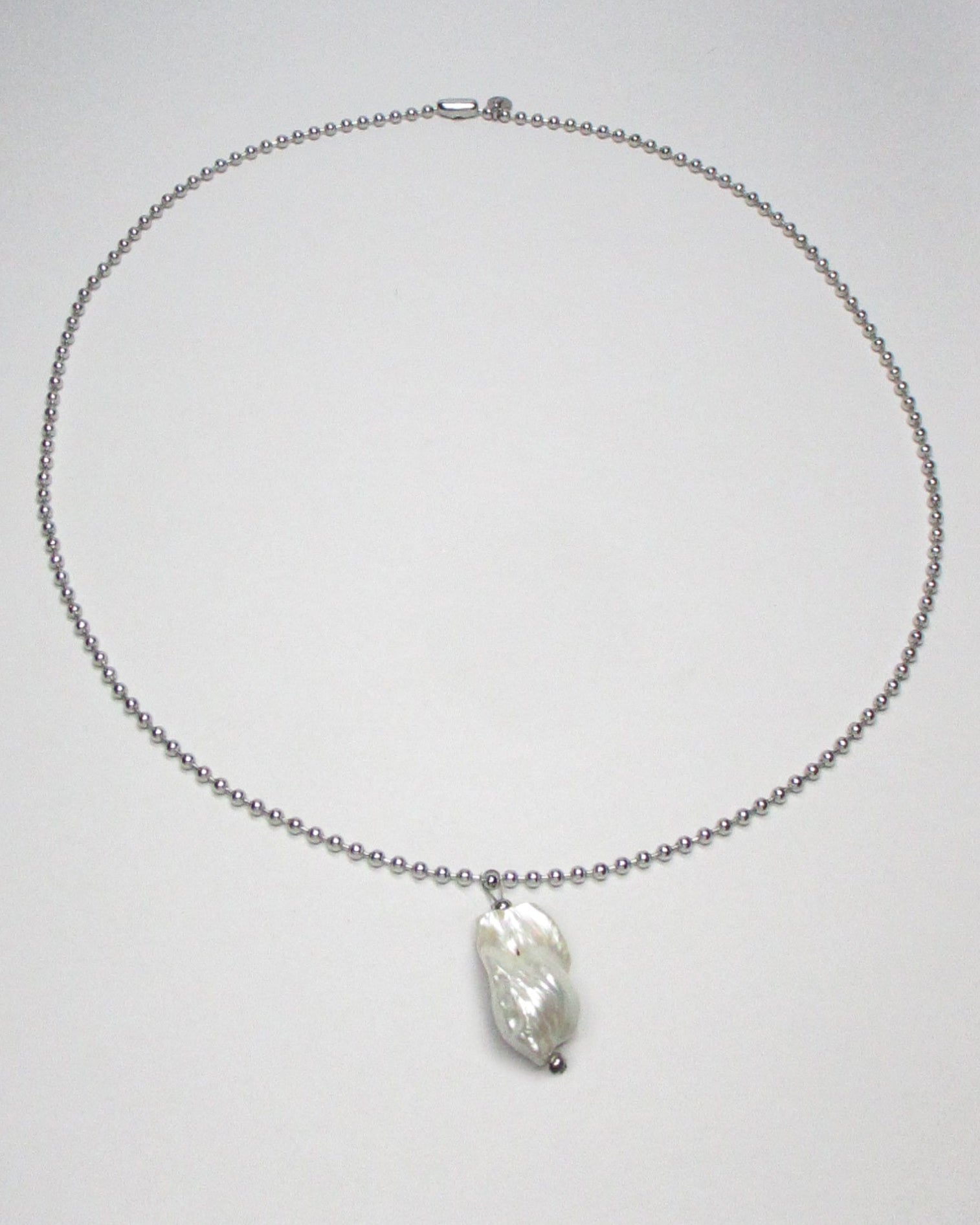 Steel ball chain with baroque freshwater pearl pendant still portrait