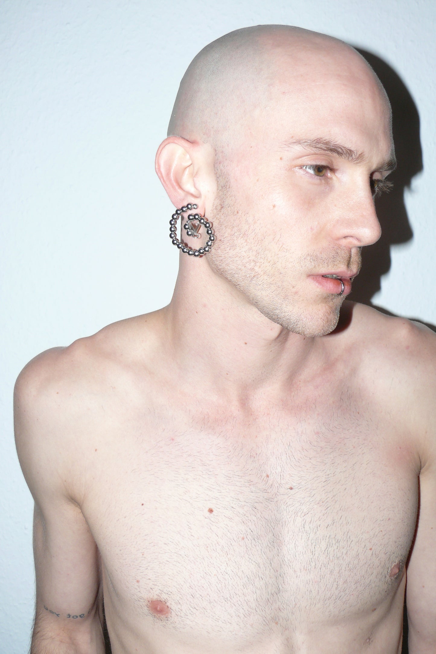 Steel beaded spiral button earrings side close-up on white model