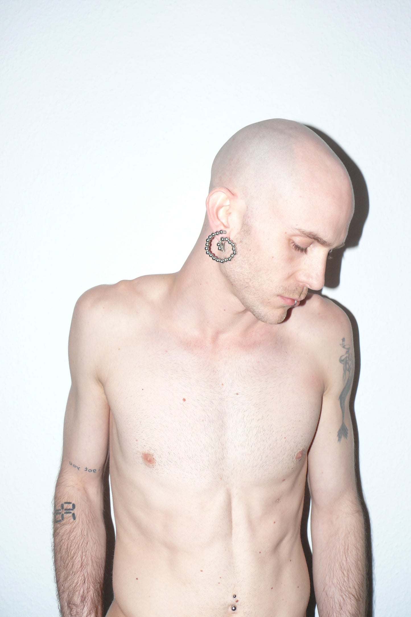 Steel beaded spiral button earrings side portrait on white model