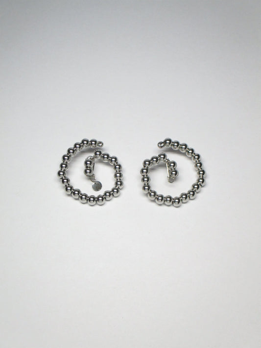 Steel beaded spiral button earrings still portrait