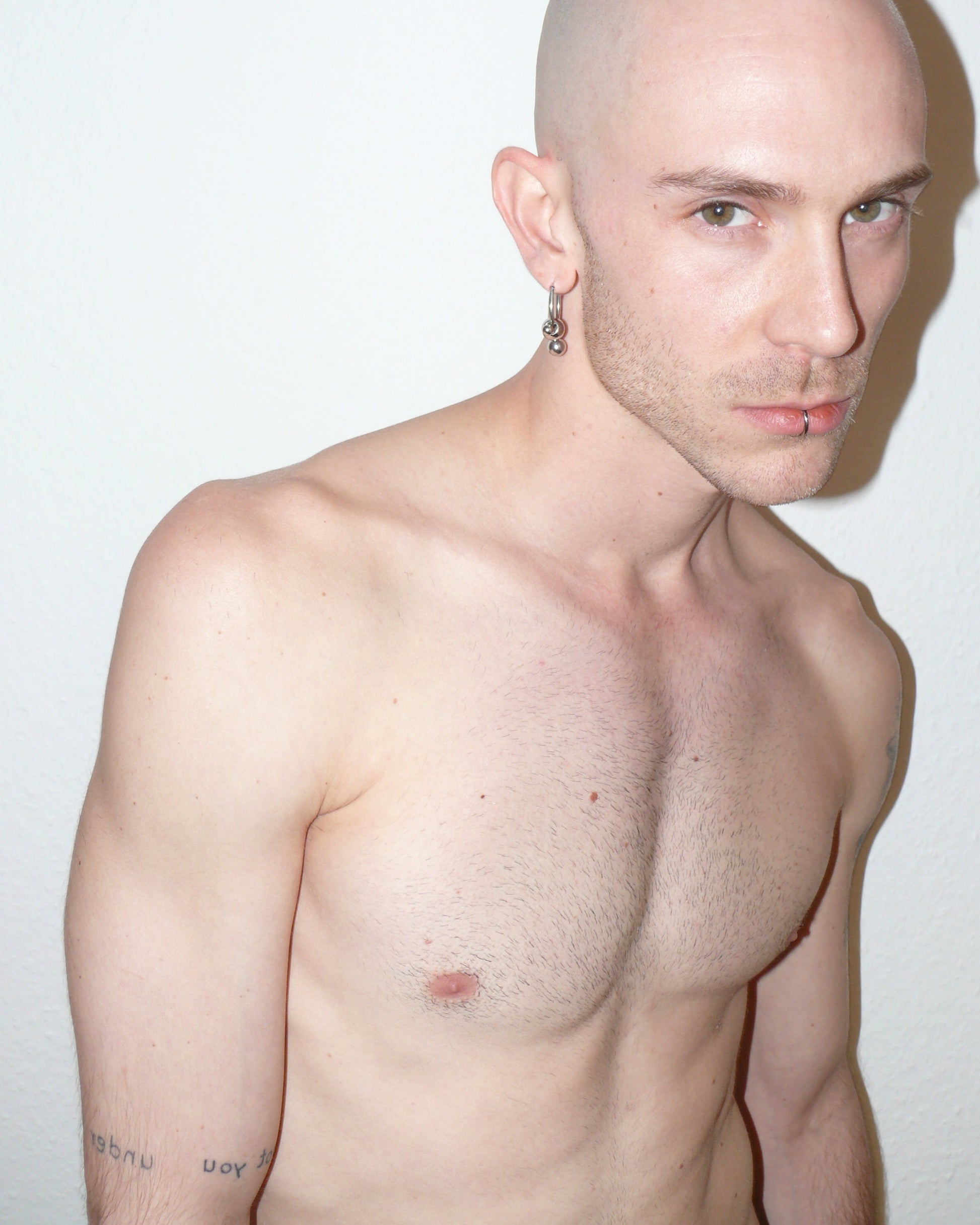 Steel hoops earrings with banana piercings decoration side frontal portrait on model