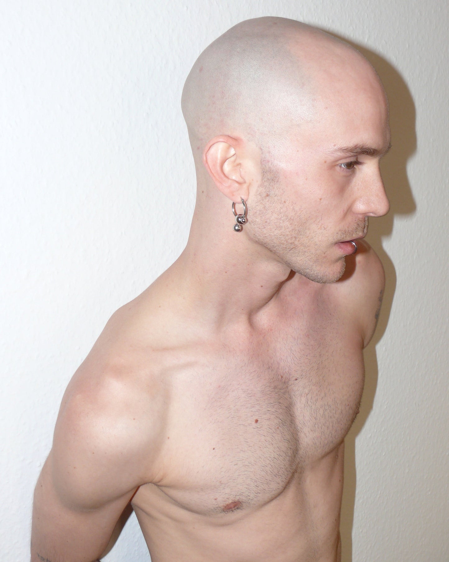 Steel hoops earrings with banana piercings decoration side portrait on model