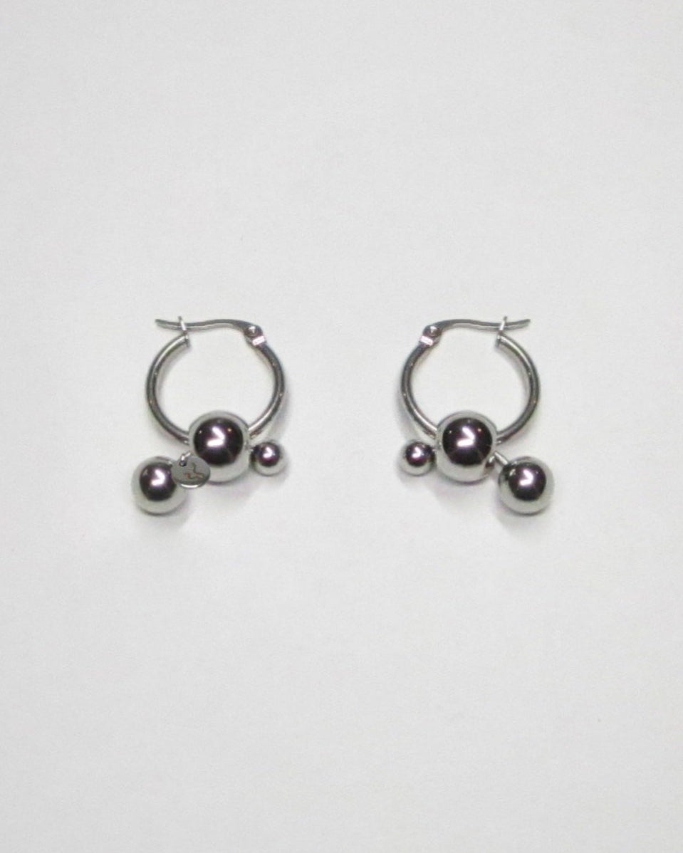 Steel hoops earrings with banana piercings decoration still portrait