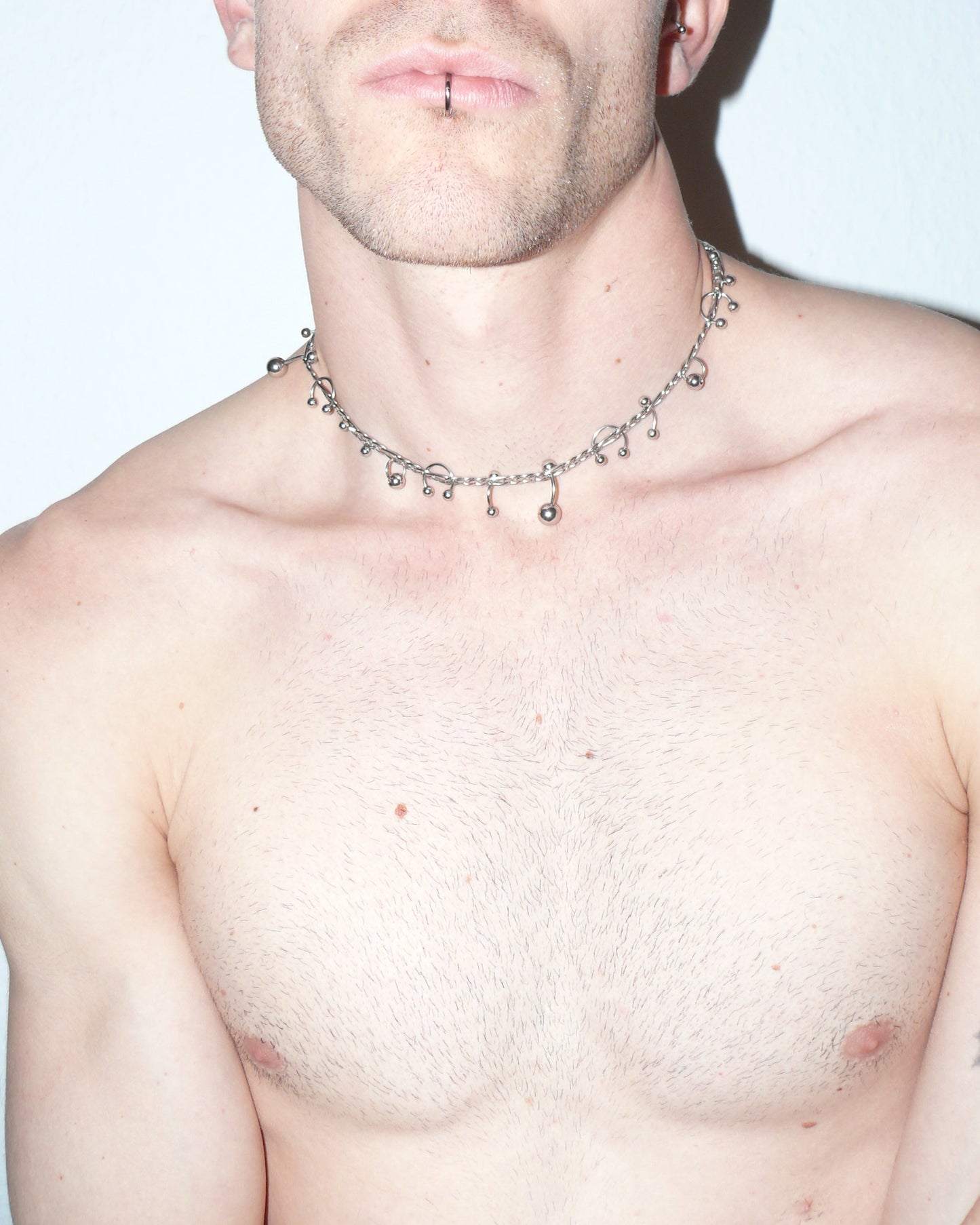 Steel mixed piercings necklace close-up on model