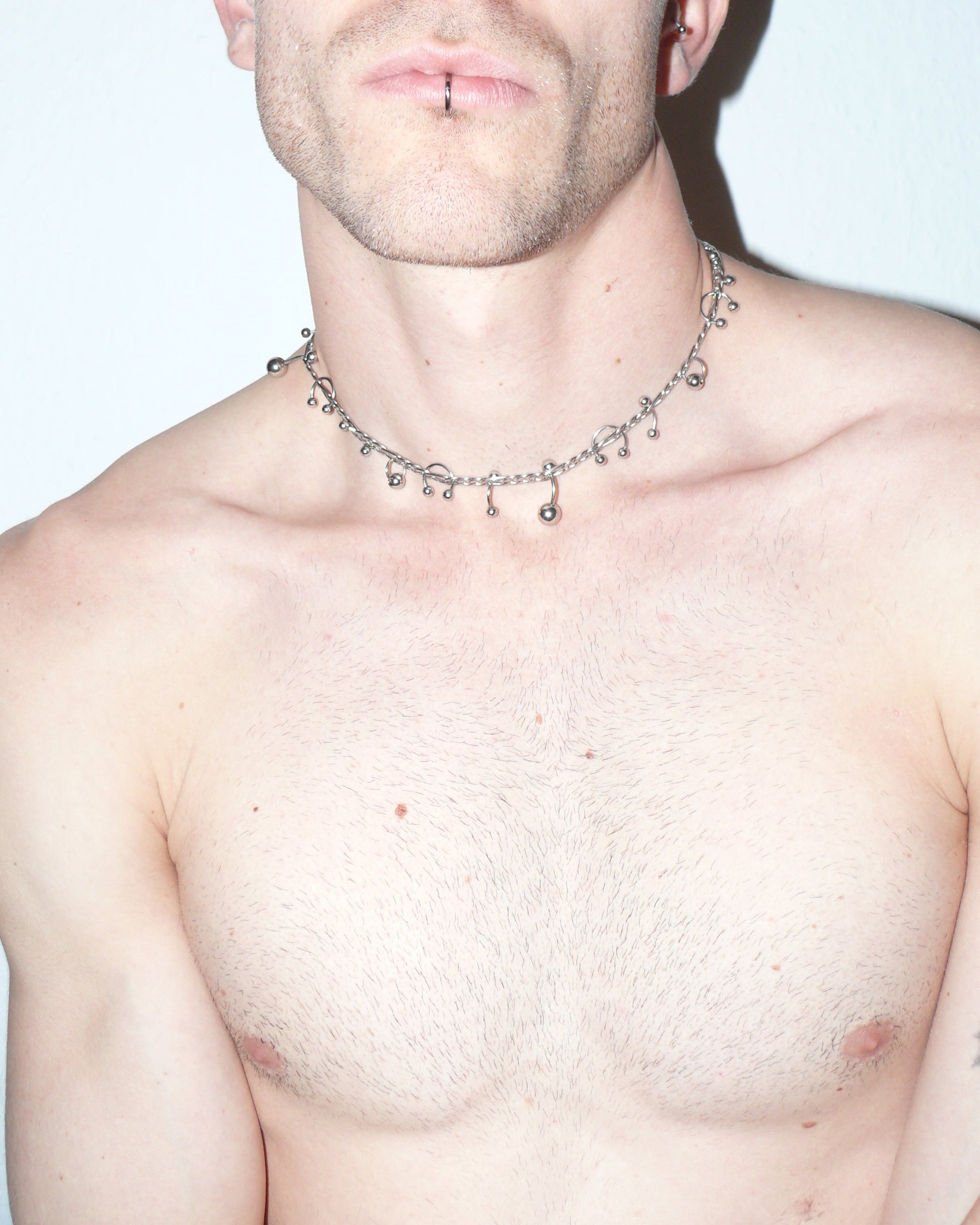 Steel mixed piercings necklace close-up on model