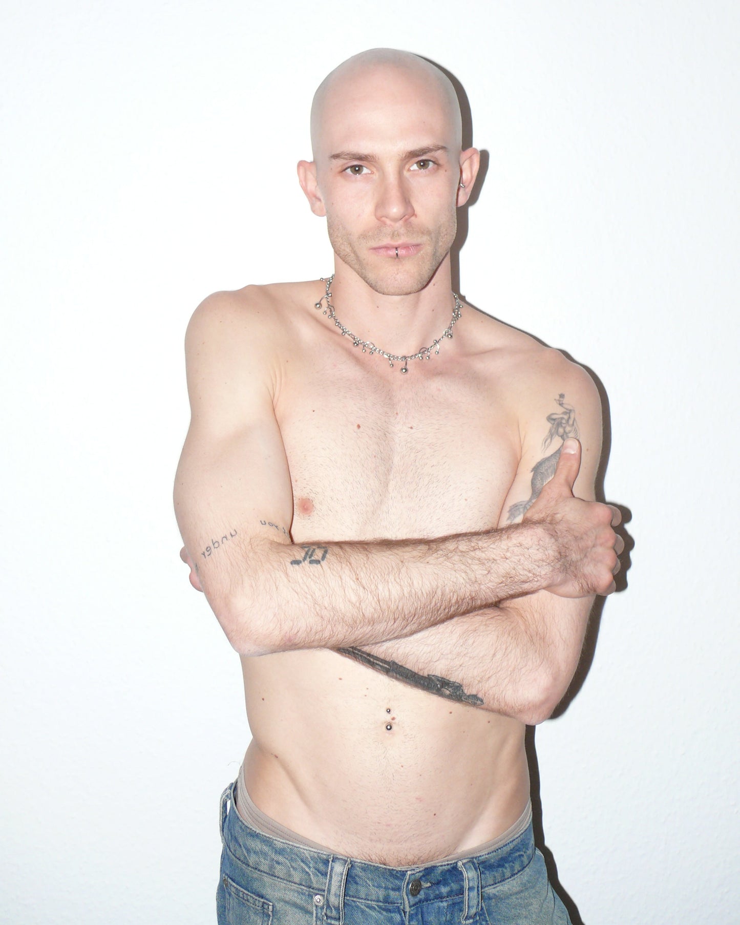 Steel mixed piercings necklace portrait on model with crossed arms