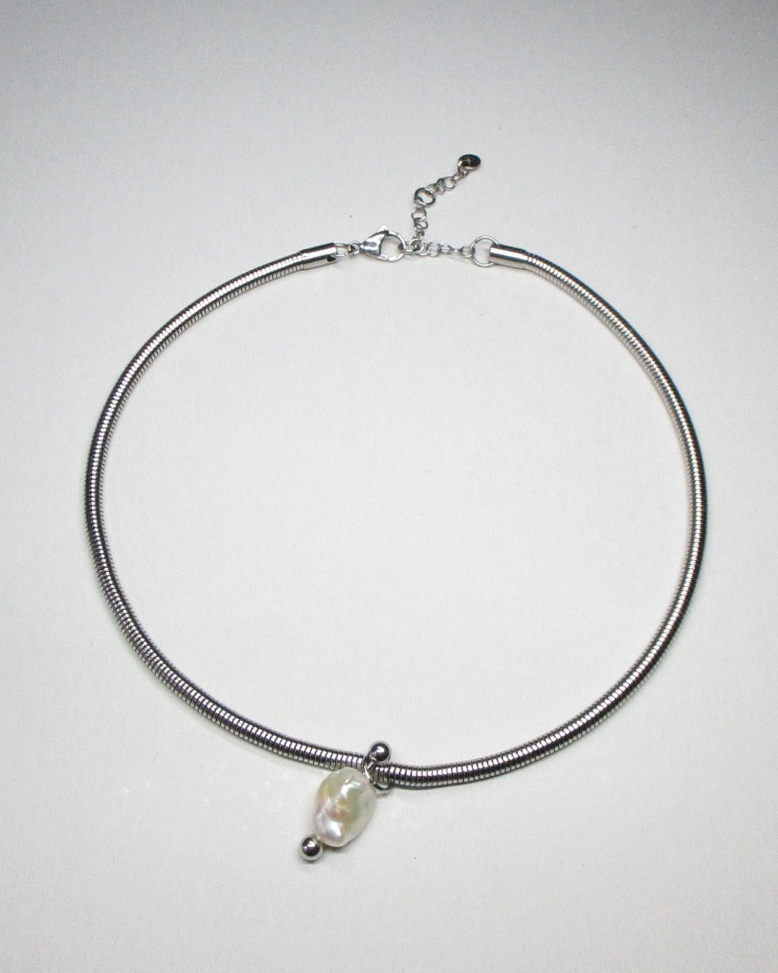 Steel snake chain with pearl pendant decorated with piercing still portrait