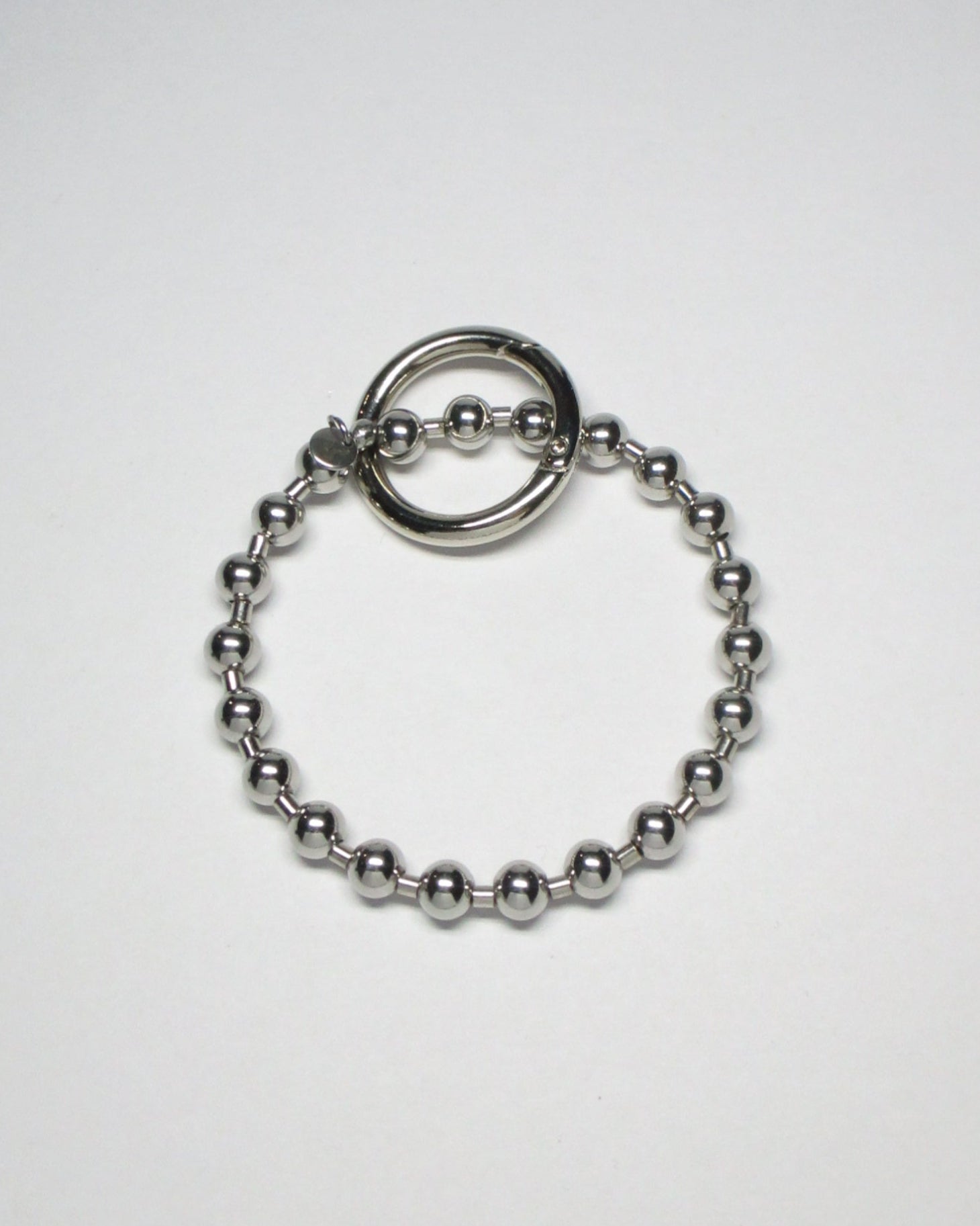 Stell ball chain key and cock ring still portrait