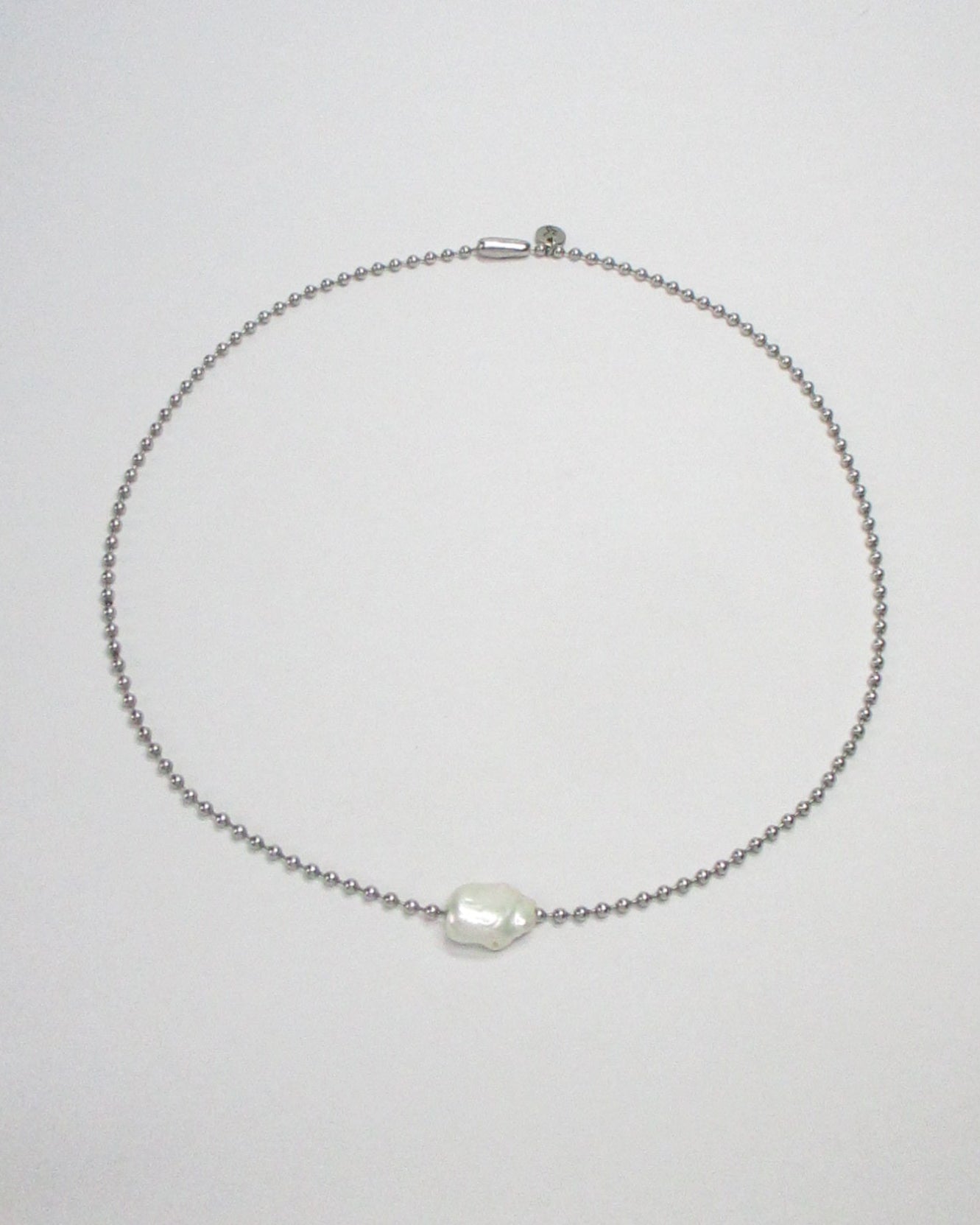 Stell ball chain with swinging pearl bead still portrait