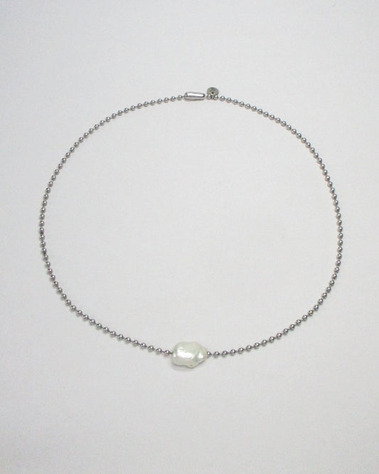 Stell ball chain with swinging pearl bead still portrait